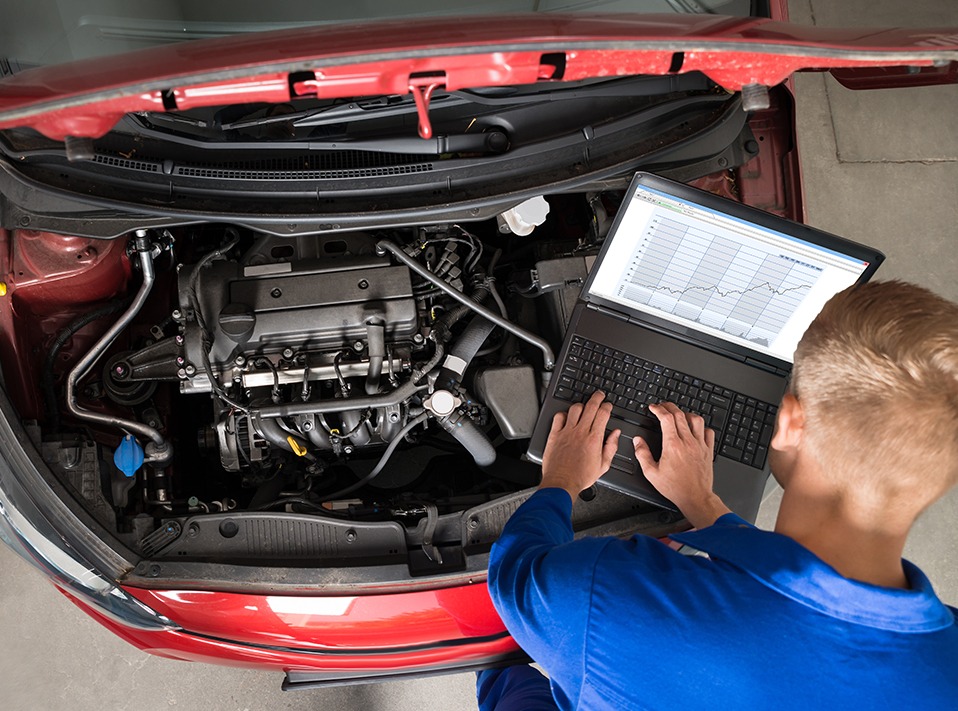 Mechanic pluging into a vehicles ecu system - Car Diagnostics Glasgow